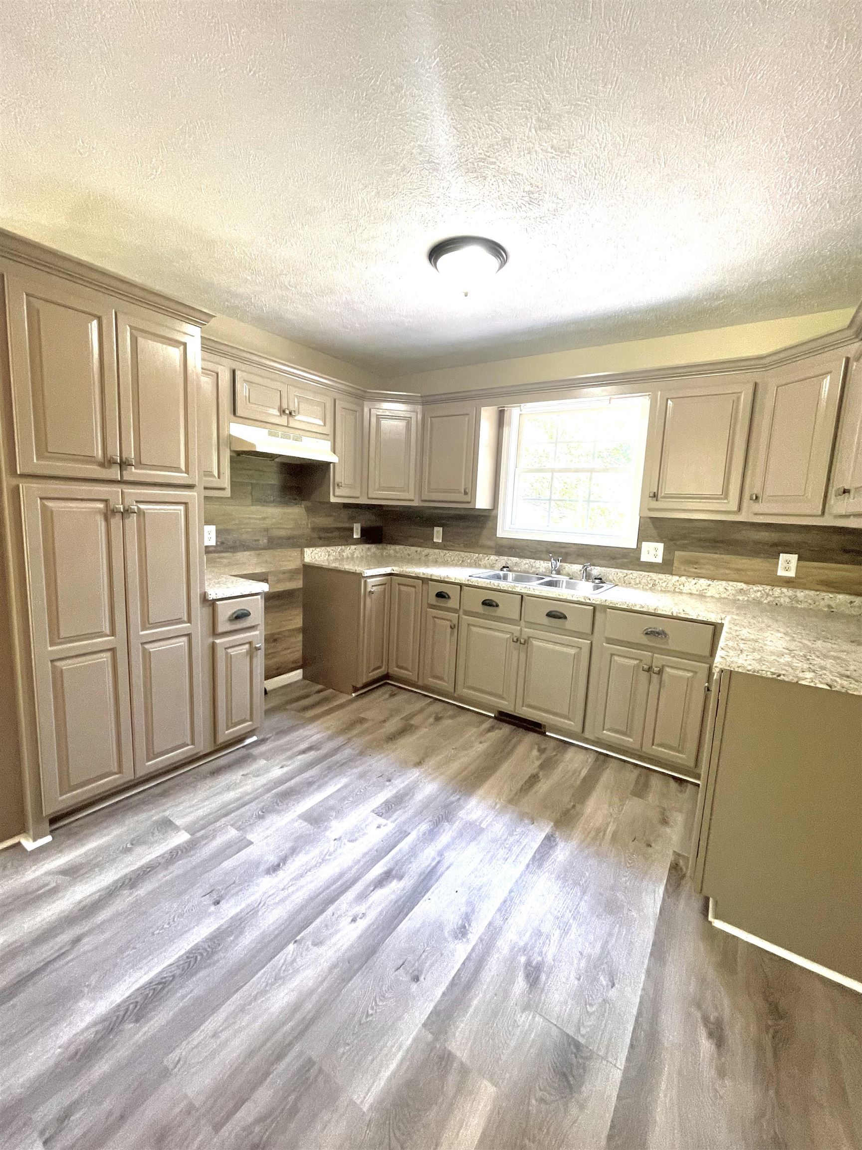 131 Wayne Elam Road Ramer, TN 38367 - Photo 3 of 15 a large kitchen with cabinets a sink and appliances