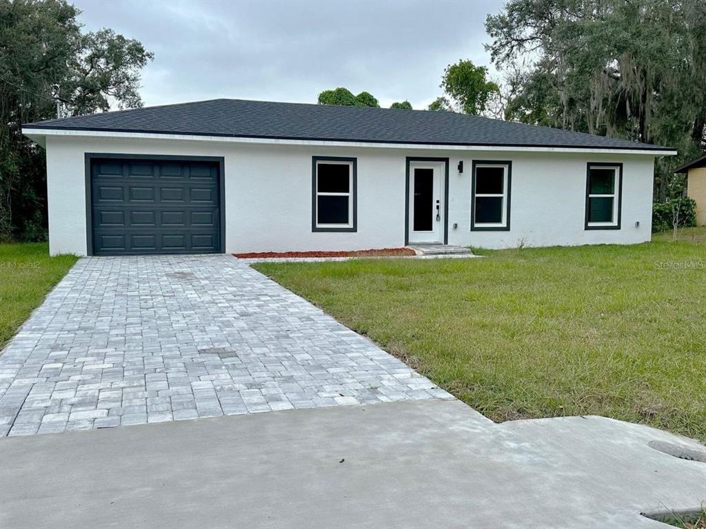 front view of a house with a yard and trees