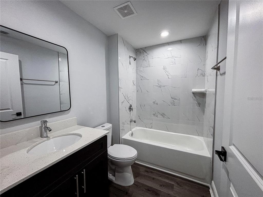 21 Locust Course Radiel Ocala, FL 34472 - Photo 6 of 8 a bathroom with a granite countertop sink a toilet and shower