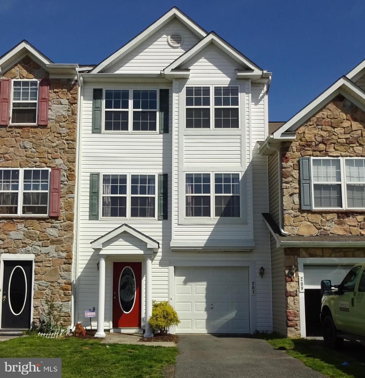 207 Canvasback Way Cambridge, MD 21613 - Photo 1 of 30 a front view of a house with garden