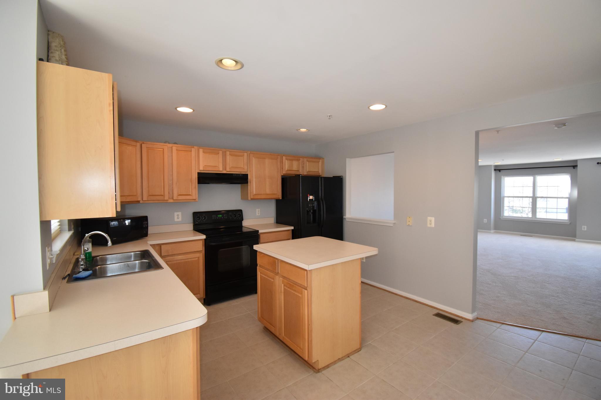 207 Canvasback Way Cambridge, MD 21613 - Photo 11 of 30 a kitchen that has a sink and a stove in it