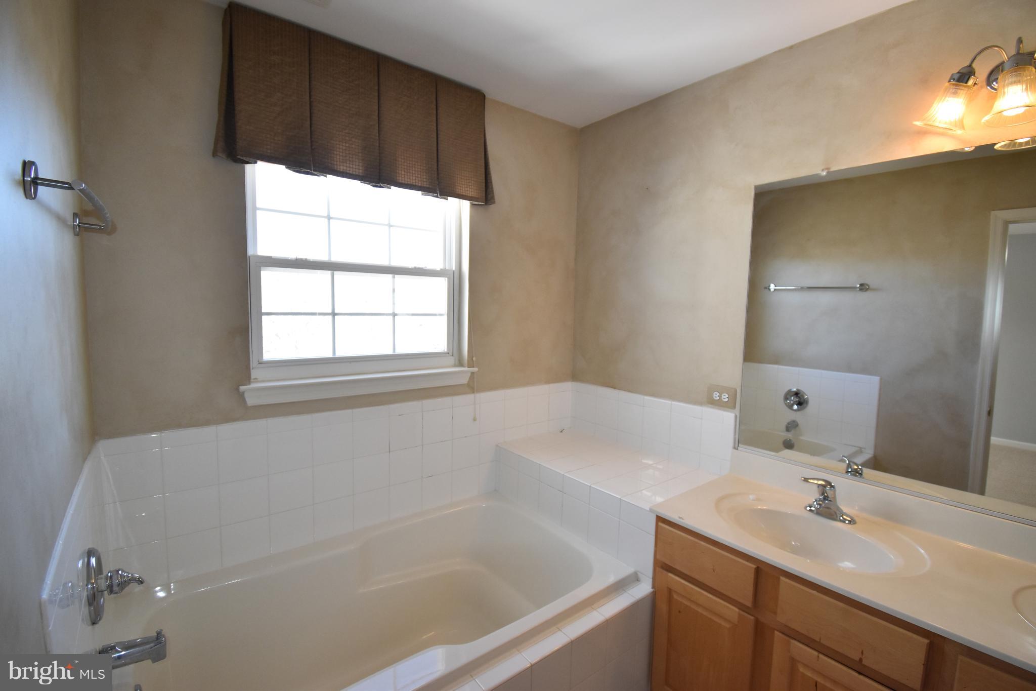 207 Canvasback Way Cambridge, MD 21613 - Photo 19 of 30 a white bath tub sitting next to a white sink