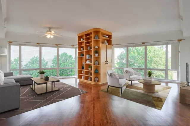 a living room with furniture and a large window with outer view