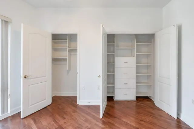a bathroom with a granite countertop sink and a toilet