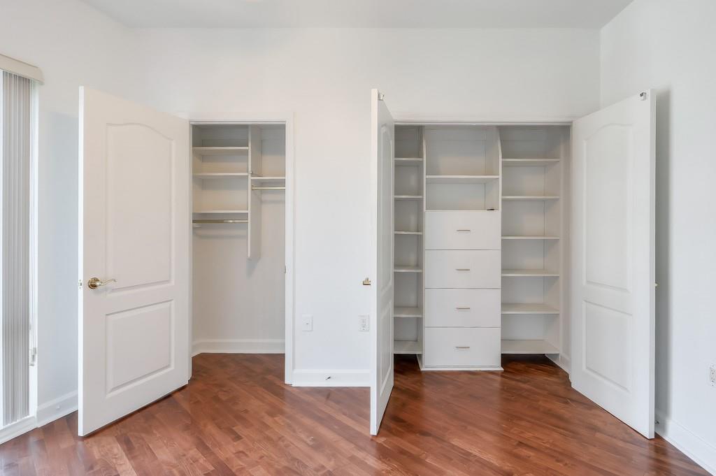 3475 Oak Valley Road Northeast, Unit 530 Atlanta, GA 30326 - Photo 25 of 37 an empty room with wooden floor closet and windows