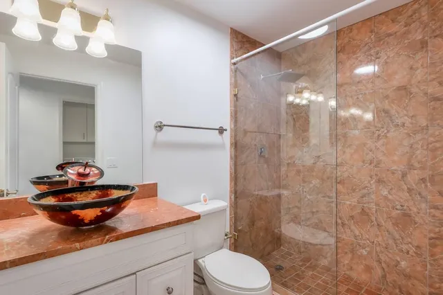 a kitchen with granite countertop a sink stove and microwave