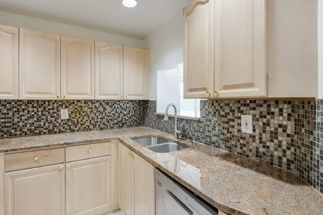 a kitchen with a sink and cabinets