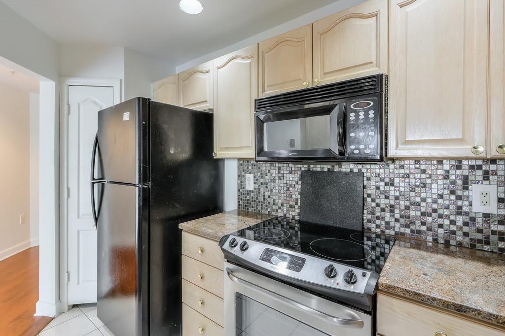 3475 Oak Valley Road Northeast, Unit 530 Atlanta, GA 30326 - Photo 30 of 37 a kitchen with a stove and a refrigerator