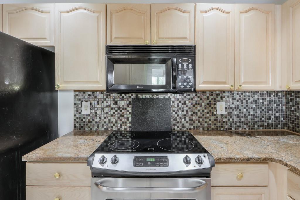 3475 Oak Valley Road Northeast, Unit 530 Atlanta, GA 30326 - Photo 31 of 37 a stove top oven sitting inside of a kitchen
