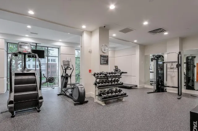 a room with gym equipment and a large mirror