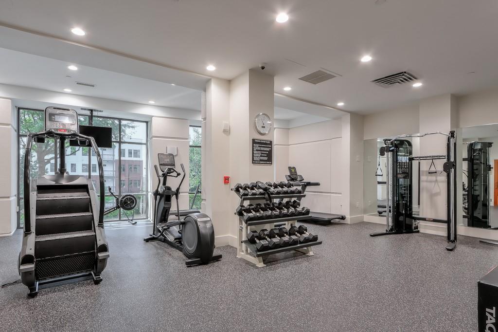 3475 Oak Valley Road Northeast, Unit 530 Atlanta, GA 30326 - Photo 10 of 37 a room with gym equipment and a large mirror