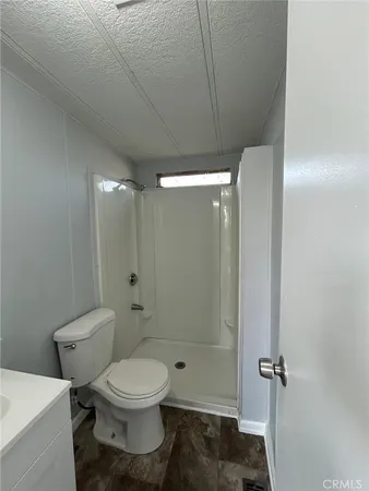 a bathroom with a toilet and shower