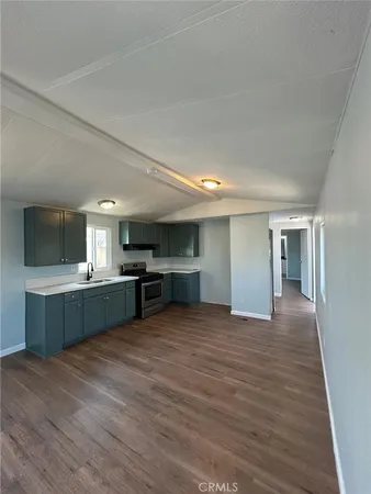 a view of a kitchen with a sink and cabinets