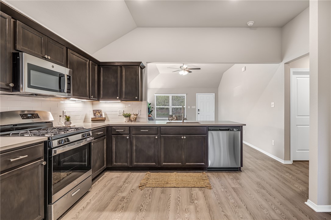 1220 High Street Navasota, TX 77868 - Photo 6 of 17 a kitchen with stainless steel appliances granite countertop a stove a sink and a microwave