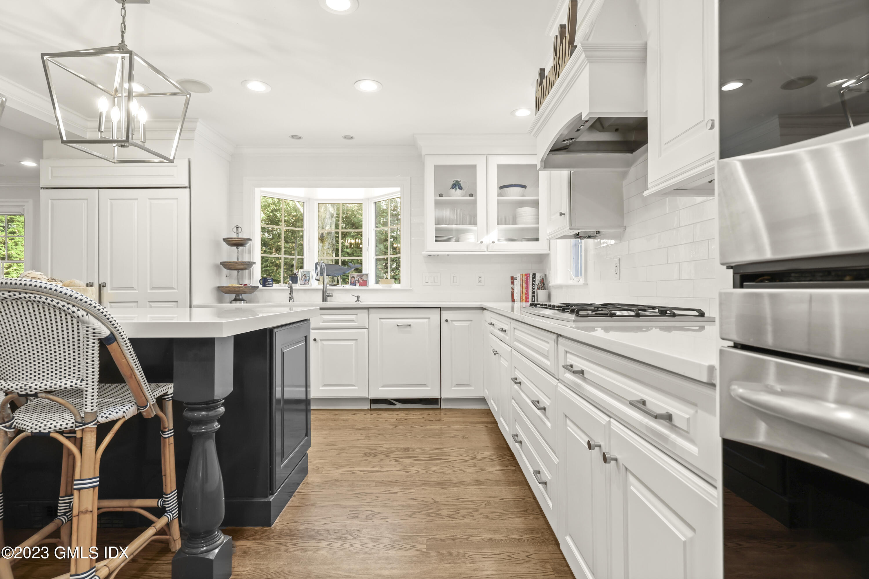 14 Rainbow Drive Riverside, CT 06878 - Photo 7 of 29 a kitchen with kitchen island granite countertop a sink appliances cabinets and a large window