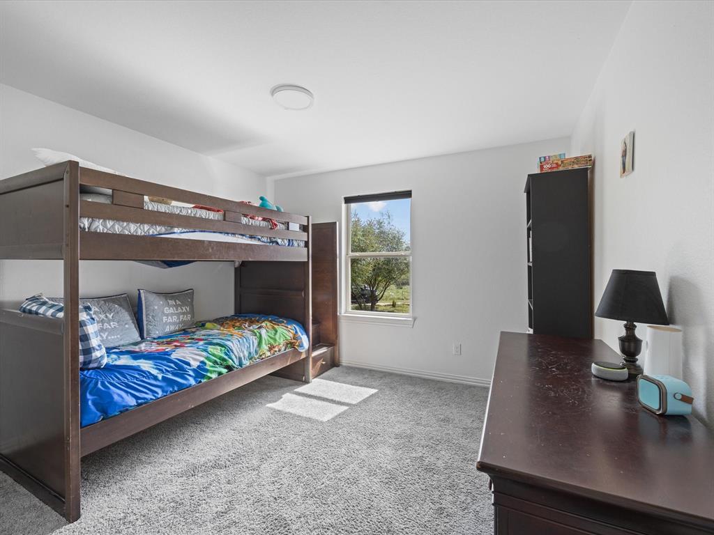 781 Alsdorf Road Ennis, TX 75119 - Photo 11 of 39 a bedroom with a bed and a window