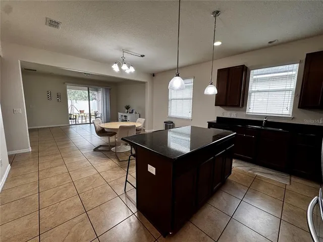 a kitchen with a sink a counter top space and cabinets