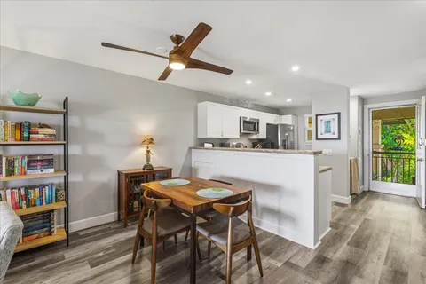 a kitchen with stainless steel appliances granite countertop a sink a stove a microwave oven and a refrigerator