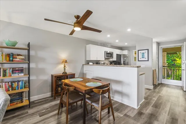 a kitchen with stainless steel appliances granite countertop a sink a stove a microwave oven and a refrigerator