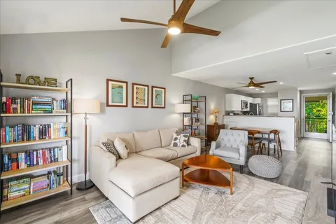 a room with furniture wooden floor and a chandelier