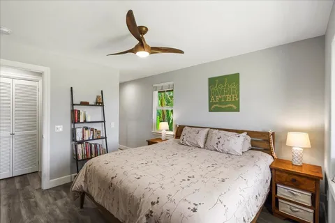a living room with furniture a flat screen tv and a large window
