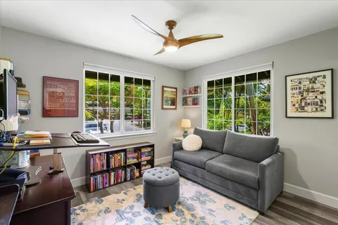 a view of a workspace with furniture and a window