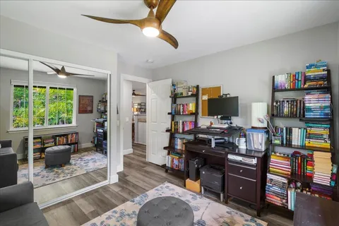 a living room with furniture and a book shelf