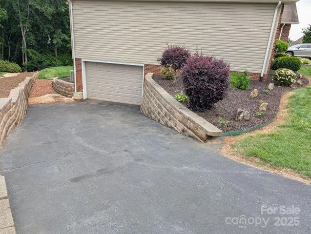 a view of backyard with potted plants and a garage