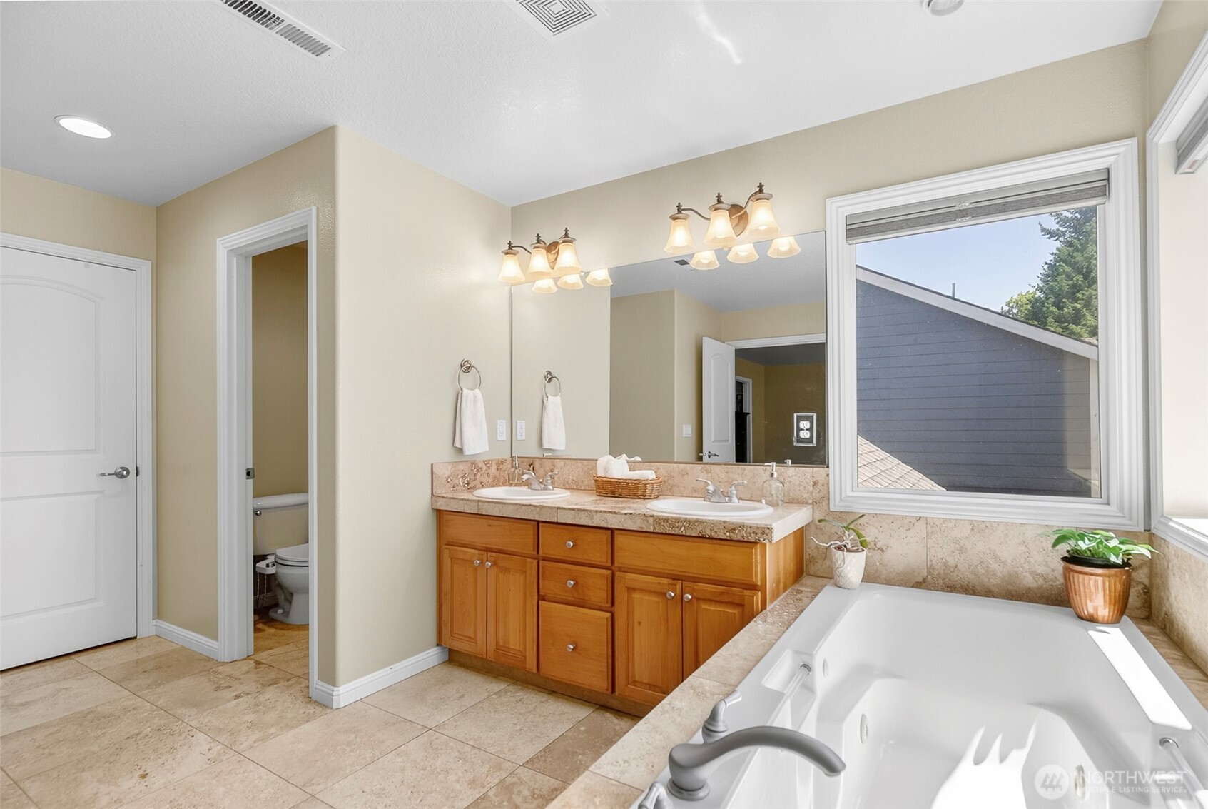 16715 Northeast 5th Street Vancouver, WA 98684 - Photo 17 of 34 a spacious bathroom with a granite countertop sink and a large mirror