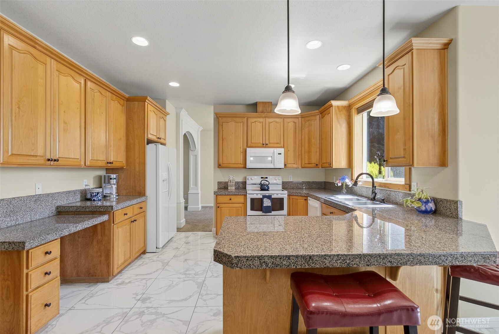 16715 Northeast 5th Street Vancouver, WA 98684 - Photo 4 of 34 a kitchen with granite countertop a sink a counter top space appliances and cabinets
