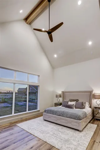 a spacious bedroom with a bed and window