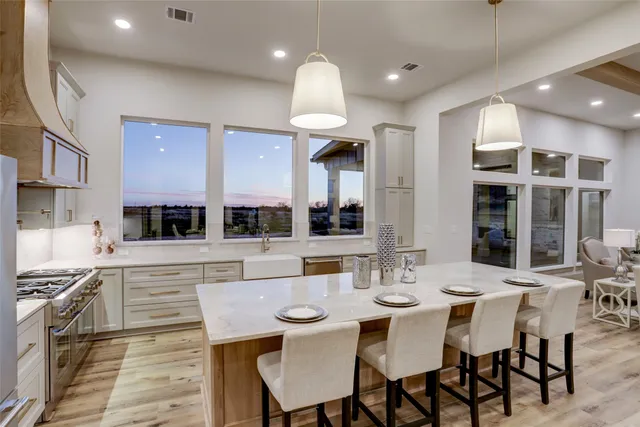 a large kitchen with a table and chairs