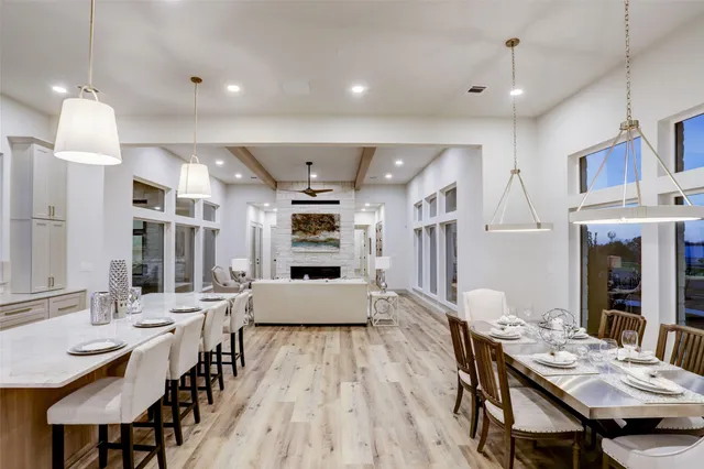 a large kitchen with a table and chairs