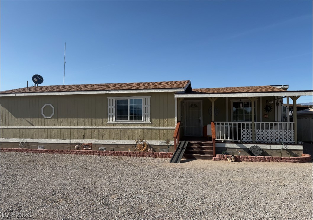 A charming single-story residence with a welcoming front porch, perfect for enjoying quiet afternoons.