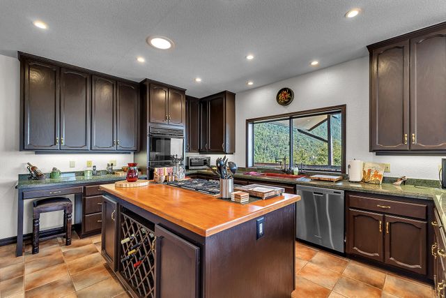 a kitchen with a sink stove top oven and cabinets