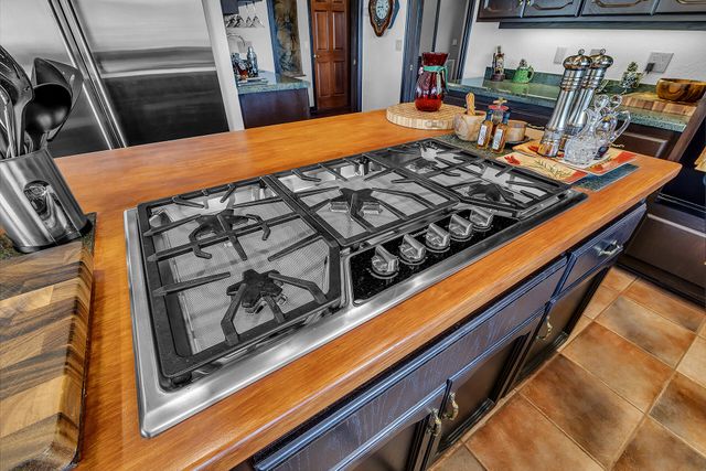 a kitchen with kitchen island a stove and a sink
