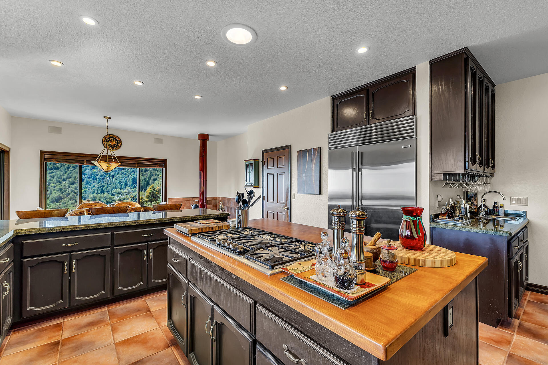 24740 Pioneer Road Idyllwild, CA 92549 - Photo 16 of 59 a kitchen with kitchen island a stove and a sink