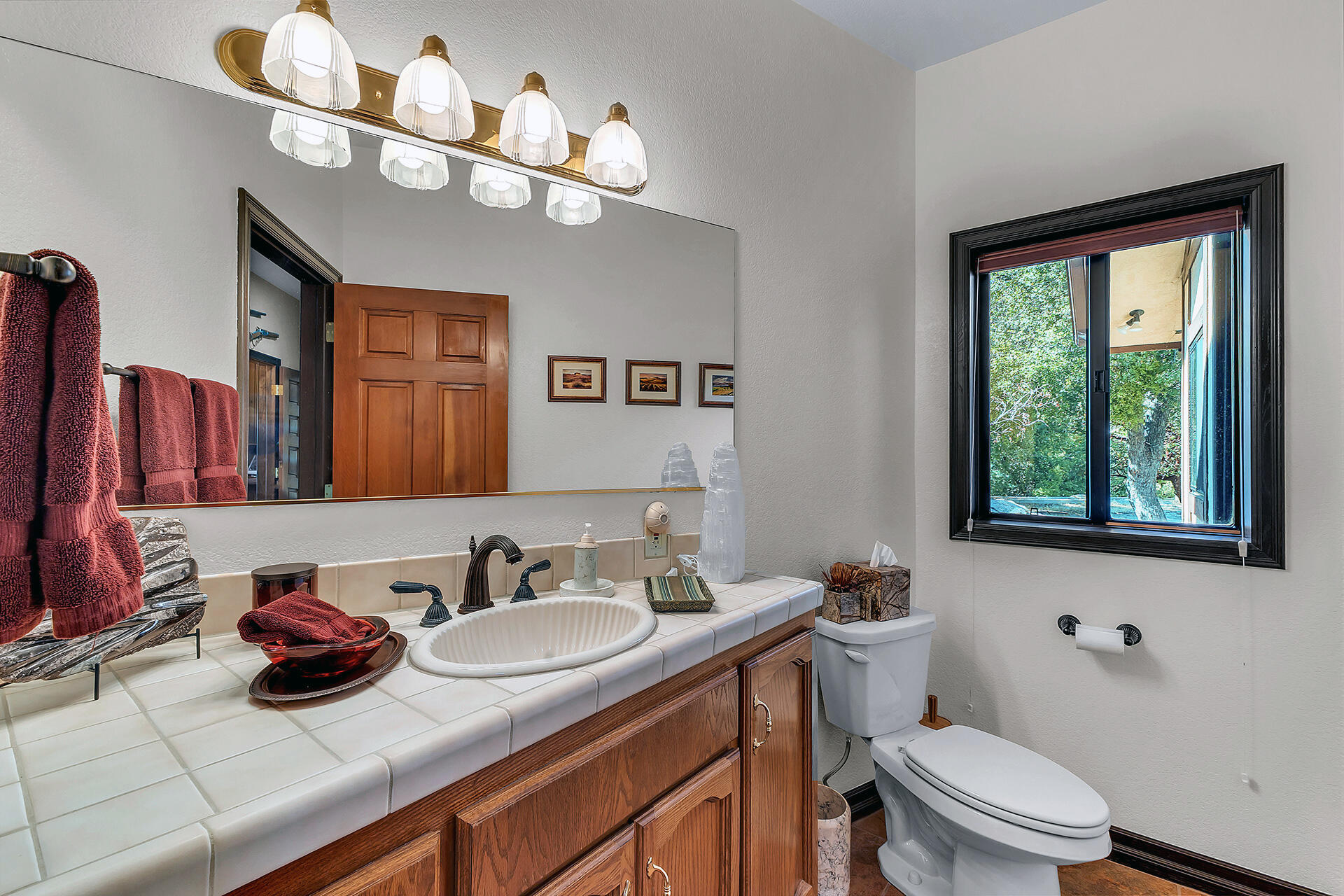 24740 Pioneer Road Idyllwild, CA 92549 - Photo 19 of 59 a bathroom with a granite countertop sink a toilet and a mirror