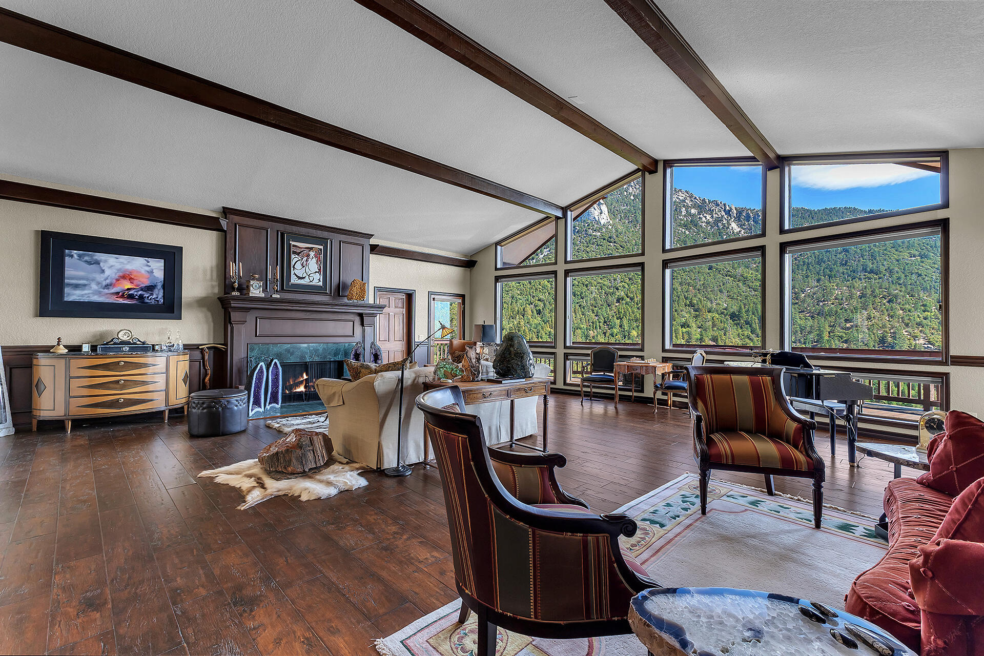 24740 Pioneer Road Idyllwild, CA 92549 - Photo 2 of 59 a living room with furniture a fireplace and large windows