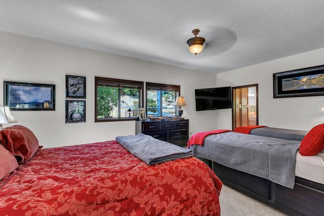 a bedroom with two beds and a flat screen tv