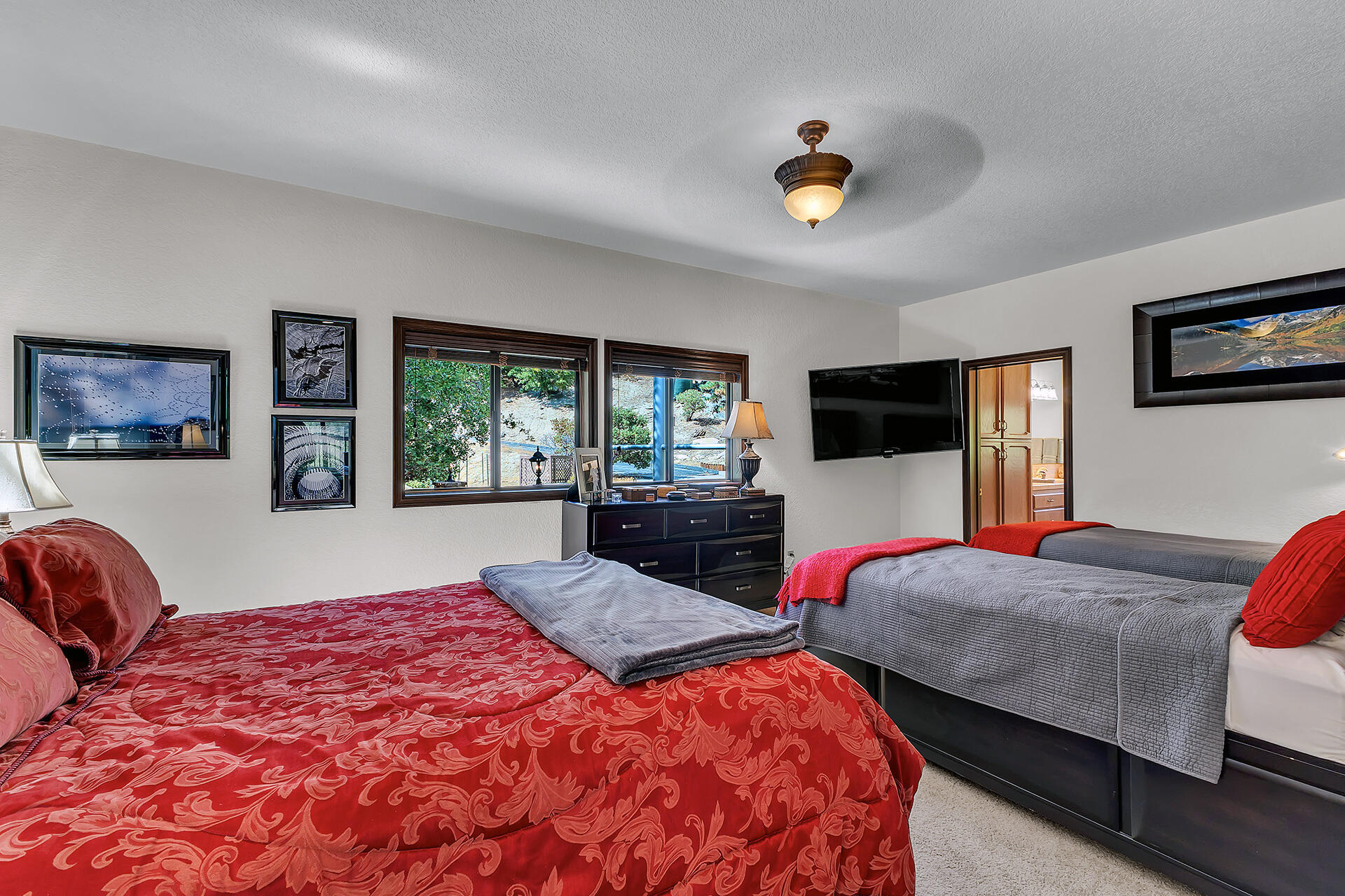 24740 Pioneer Road Idyllwild, CA 92549 - Photo 22 of 59 a bedroom with a large bed and a flat screen tv