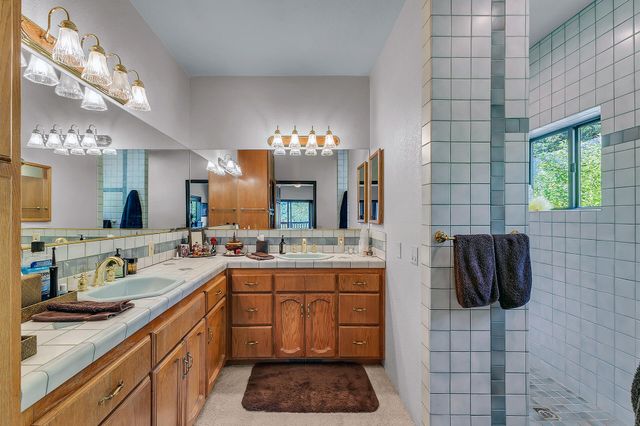 a bathroom with a sink double vanity and a mirror