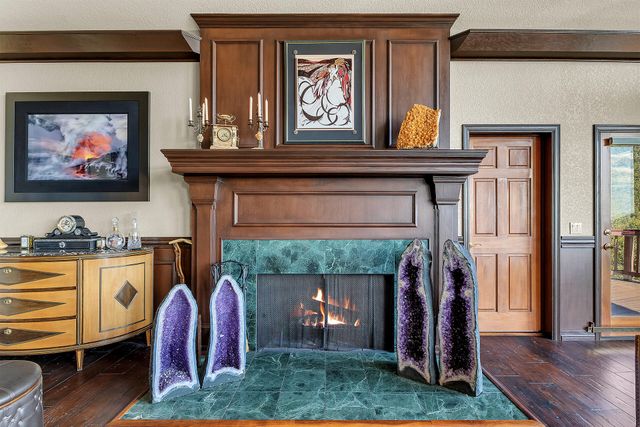 a view of hall way with furniture and a fireplace