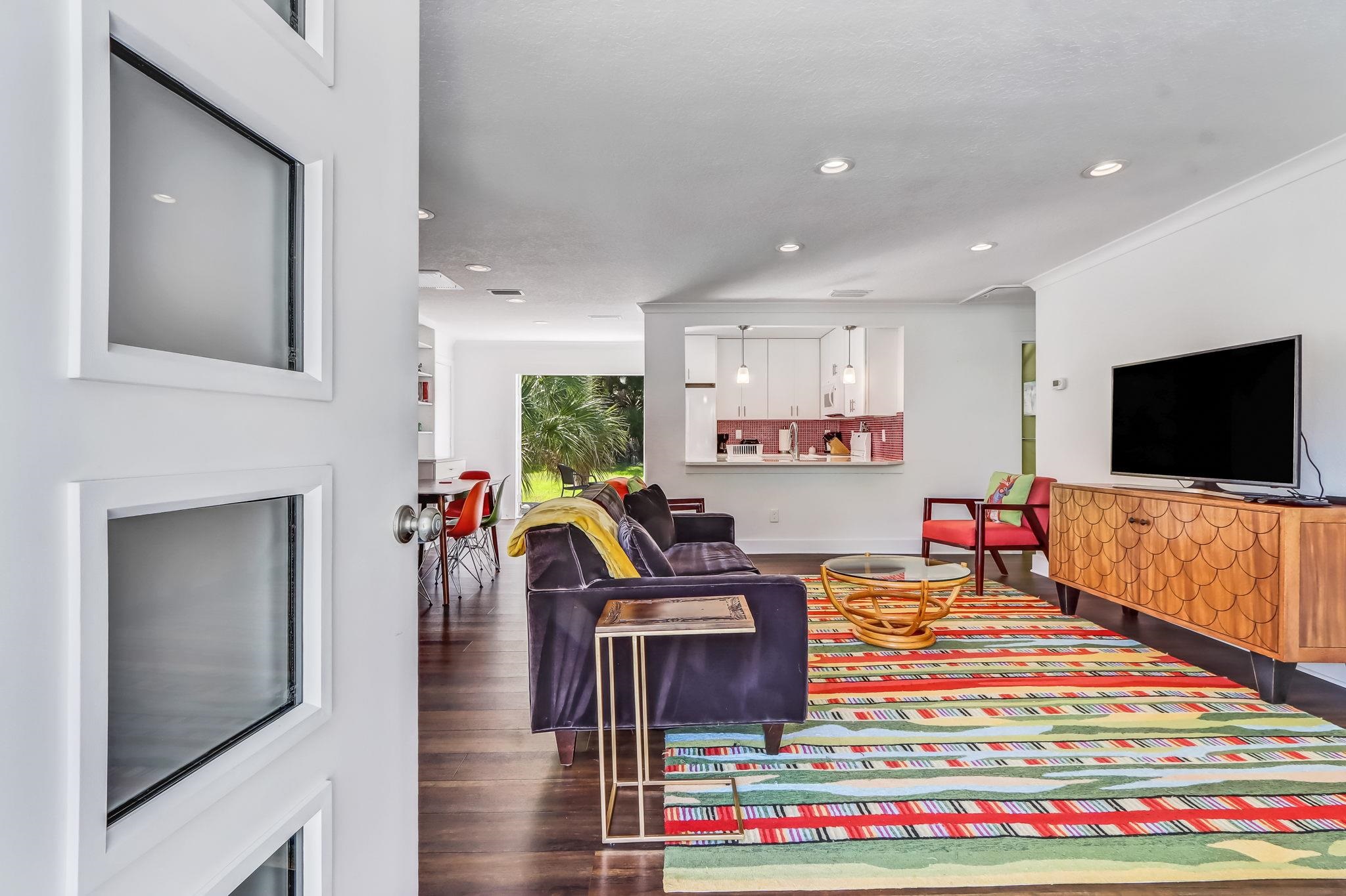 28 Atlantic Avenue St. Augustine, FL 32084 - Photo 3 of 23 a living room with furniture a flat screen tv and a fireplace