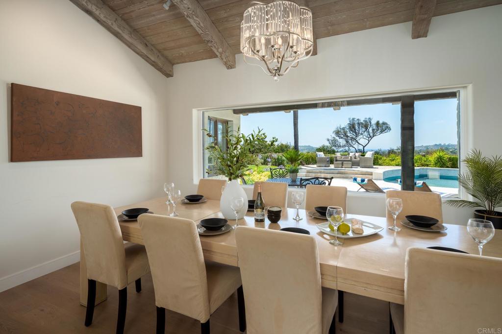 5002 El Acebo Rancho Santa Fe, CA 92067 - Photo 17 of 55 a dining room with furniture a large window and a chandelier