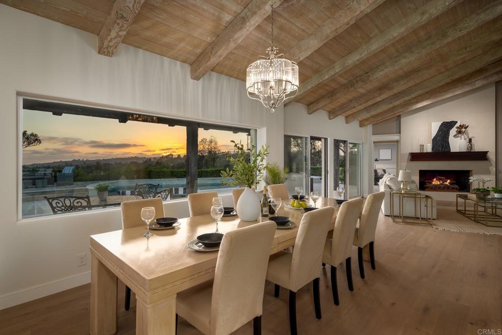 5002 El Acebo Rancho Santa Fe, CA 92067 - Photo 18 of 55 a view of a dining room with furniture a chandelier and large windows