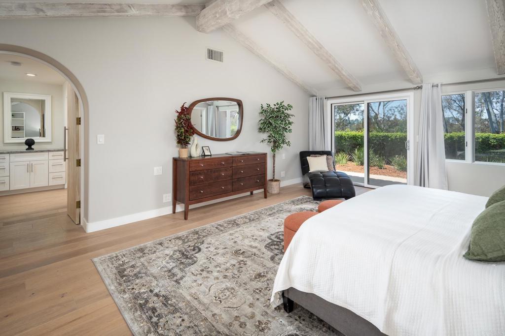 5002 El Acebo Rancho Santa Fe, CA 92067 - Photo 25 of 55 a bedroom with a bed a mirror on dresser and a large window