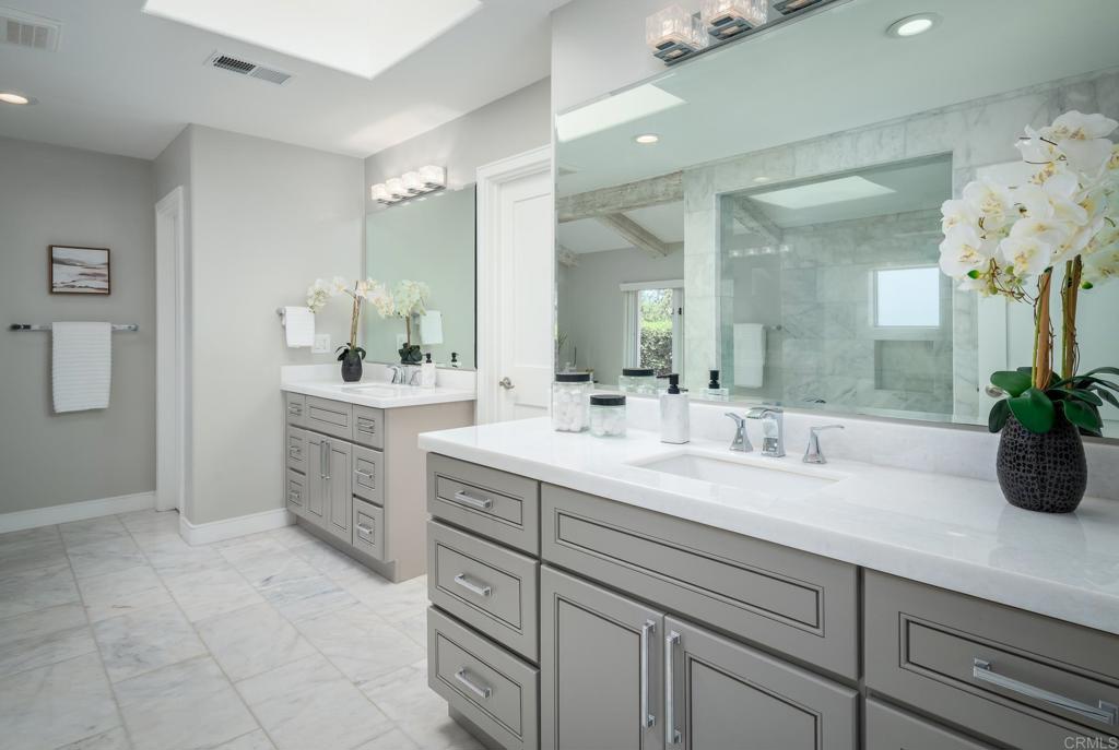 5002 El Acebo Rancho Santa Fe, CA 92067 - Photo 26 of 55 a spacious bathroom with a granite countertop sink a mirror and a