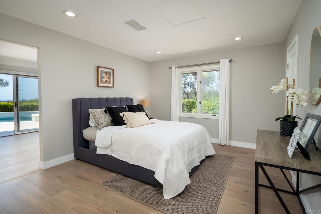 5002 El Acebo Rancho Santa Fe, CA 92067 - Photo 32 of 55 a bedroom with a bed and large windows