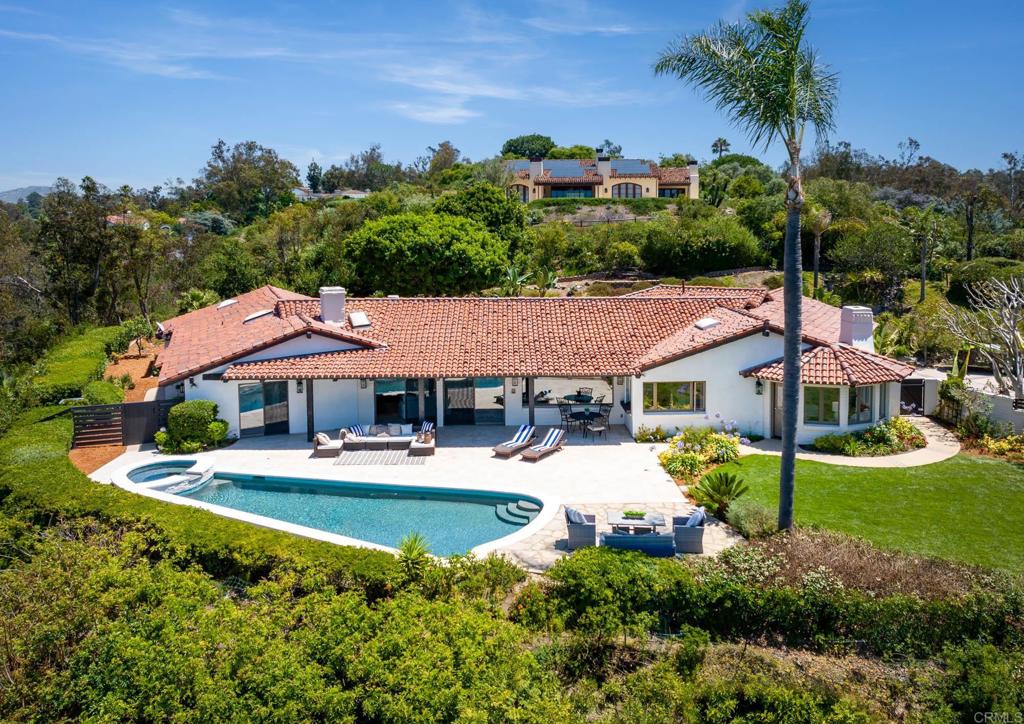 5002 El Acebo Rancho Santa Fe, CA 92067 - Photo 39 of 55 a front view of a house with a yard patio and palm tree